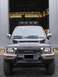 1990 Toyota 4Runner - Front view of a black Toyota 4Runner parked in front of an open garage.