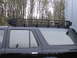 1990 Toyota 4Runner - Side profile of a black SUV equipped with a heavy-duty roof rack, with a Supermotors watermark visible on the lower right.