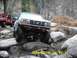 1996 Ford Bronco - White Ford Bronco navigates a rocky trail with a red Jeep following behind.
