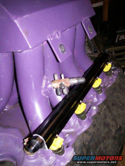Purple intake manifold with black fuel rail and yellow-capped injectors