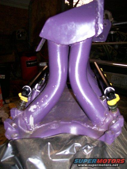 Purple intake manifold with yellow-capped fuel injectors attached