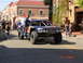 1996 Ford Bronco - A custom-built off-road truck with racing modifications is seen on a street with spectators.