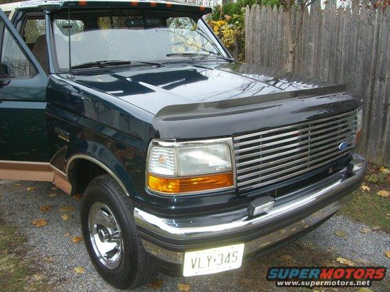 Dark green 1994 Ford Bronco front 3/4 view with chrome grille and license plate VLY-345