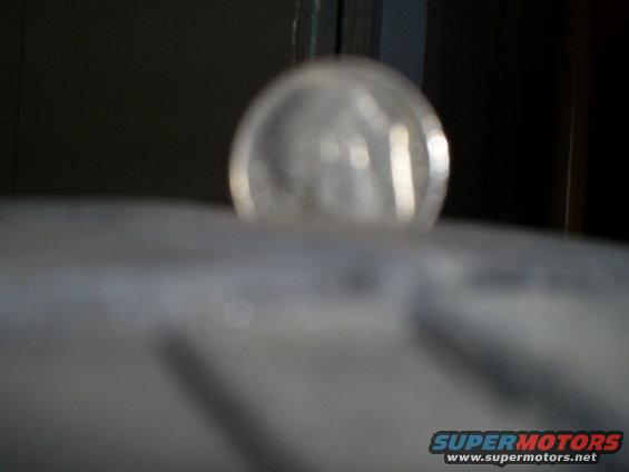 Close-up of tire tread with a clear dome light visible above it