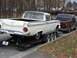 1959 Ford Ranchero - A white 1959 Ford Ranchero is towed on a trailer, with another pickup truck behind it.