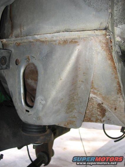 Close-up of rusted metal frame and suspension parts under a vehicle