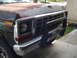 1978 Ford Bronco - The front grille and bumper of a 1978 Ford Bronco, showing signs of wear on the hood.