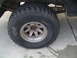 1978 Ford Bronco - Close-up of a BFGoodrich Radial Mud-Terrain T/A tire and wheel assembly, with visible suspension parts.