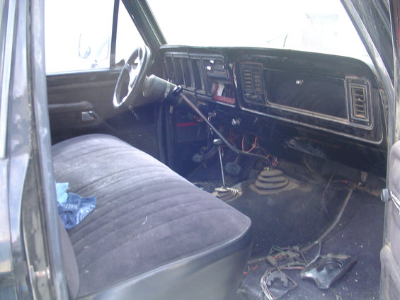 1978 Ford Bronco interior showing bench seat, dashboard, steering wheel, and floor shifter