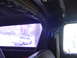 1978 Ford Bronco - View from inside a vehicle shows a roll cage and a white pickup truck parked outside.
