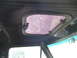1978 Ford Bronco - Close-up of a vehicle's interior roof showing a small, damaged pop-open window.