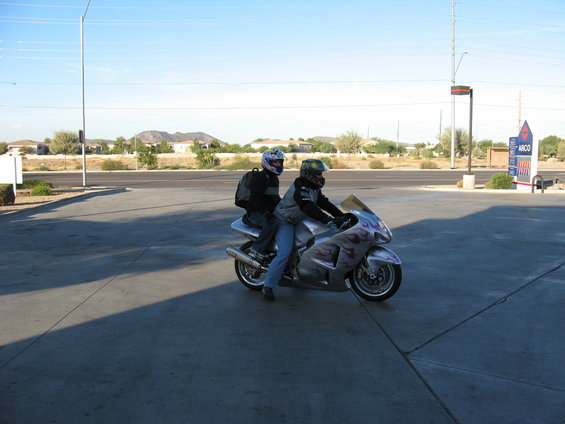 Silver motorcycle with flame graphics, two riders