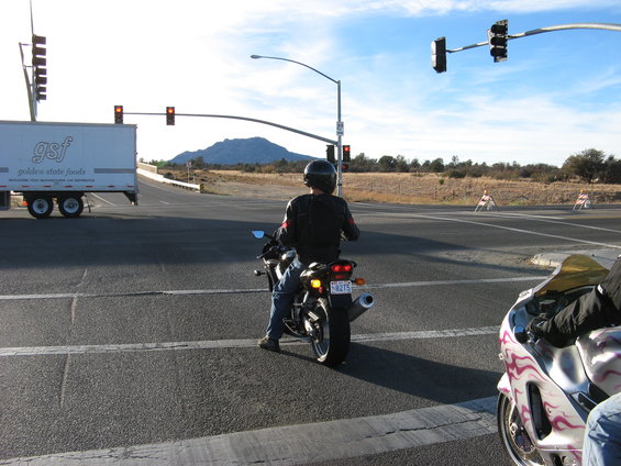 Motorcycle at intersection, license plate 8275