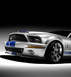 1999 Ford Mustang - This 2007-2009 Shelby GT500 Mustang features a distinctive front grille and iconic racing stripes.