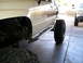 1986 Toyota Hilux - This pickup truck features aftermarket rock sliders and oversized tires, suggesting off-road modifications.