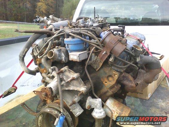 Engine with blue distributor cap and rusted components
