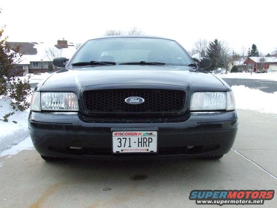 Front view of a black 2003 Ford Crown Victoria with a black grille and Wisconsin plates