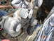 1996 Ford Bronco - Close-up view of engine components, including belts and pulleys, showing signs of wear and dust.