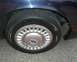 1999 Ford Crown Victoria - Close-up of a car's wheel and tire, showing the tread and hubcap details.
