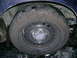1999 Ford Crown Victoria - A close-up view of a car's wheel and tire, a Ford logo on the hubcap.