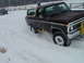 1979 Ford Bronco - A Ford Bronco navigates through deep snow, with another vehicle visible in the background.
