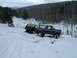 1979 Ford Bronco - A brown 1979 Ford Bronco tows a second Bronco through a snowy, wooded landscape.