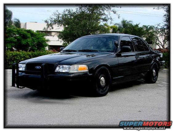 1998 Ford Crown Victoria police car with push bumper, parked outside