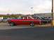 1965 Ford Falcon - Side view of a red 1965 Ford Falcon coupe at a car show.