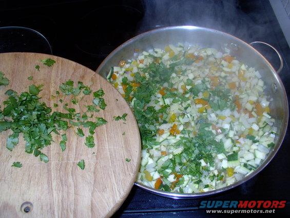 img_0212.jpg Add in the Cilantro (Corriander) too. I keep the remainder, you see on the board, to add into the sauce just before serving.