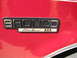1994 Ford Bronco - Close-up of the Bronco Eddie Bauer emblem on a red vehicle.