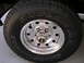 1994 Ford Bronco - This image shows a close-up of a Bridgestone Dueler A/T tire mounted on a chrome wheel.
