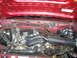 1994 Ford Bronco - A close-up view of the engine compartment, showing various hoses and mechanical parts under the hood.