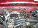 1994 Ford Bronco - The engine bay of a 1994 Ford Bronco shows its internal components and wiring.