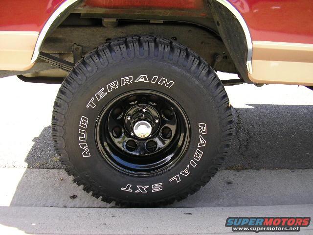 1994 Ford Bronco side view showing front wheel with MUD TERRAIN radial tire and two-tone paint