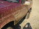1994 Ford Bronco - This Ford Bronco is covered in mud after off-roading. The 'Bronco' badge is visible on the door.