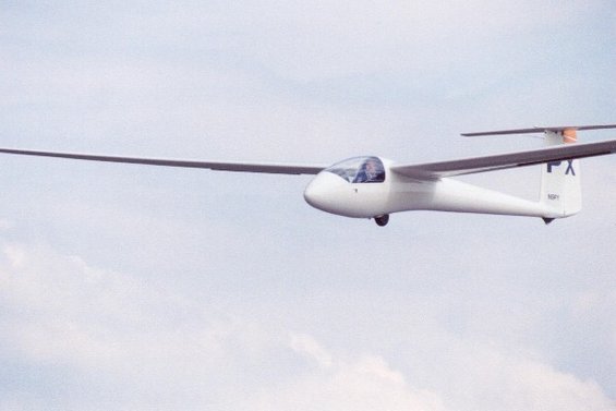 White glider aircraft in flight, with visible registration N69FY and markings FX