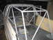 1996 Ford Bronco - This white pickup truck's interior is fitted with a custom roll cage and yellow padding, suggesting a modification for racing or off-road u…