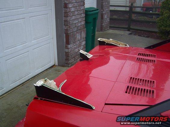 Red 1985 Toyota MR2 front with damaged pop-up headlight covers and hood vents