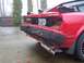 1985 Toyota MR2 - Rear view of a red 1985 Toyota MR2 showing significant damage to the bumper and body panels.