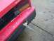 1985 Toyota MR2 - Rear view of a red Toyota car, revealing a damaged bumper and exposed internal components.