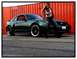 2002 Ford Mustang - Woman poses with a green 2002 Ford Mustang GT.