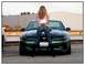 2002 Ford Mustang - Woman poses in front of a dark green 2002 Ford Mustang GT.