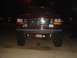 1992 Ford Bronco - Front view of a red 1992 Ford Bronco parked at night, showing its grille and headlights.