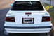1991 Mazda MX-6 - Rear view of a white 1991 Mazda MX-6, showing the taillights and spoiler.