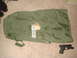1992 Ford Bronco - A green duffel bag and a handgun are placed on a carpeted floor.