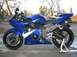 2005 Yamaha R1 - A blue motorcycle is parked outdoors, with a watermark from SUPERMOTORS.NET visible on the lower right.