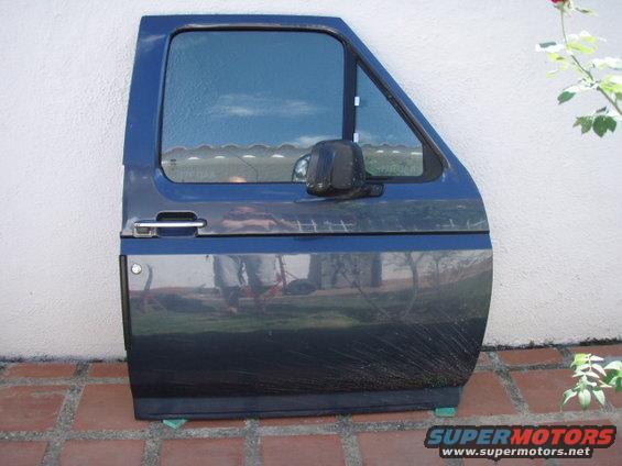 Blue truck door with chrome handle and black mirror