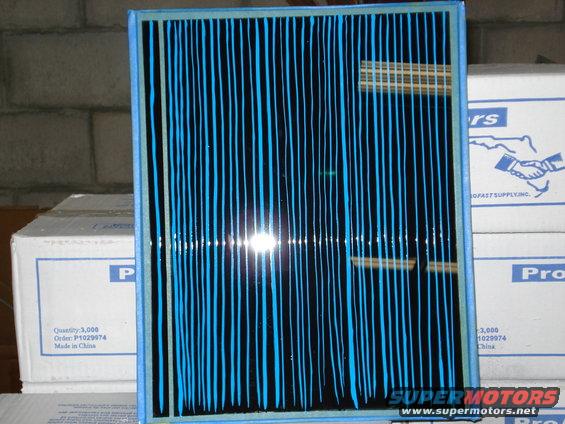 Blue and black striped air filter in front of cardboard boxes