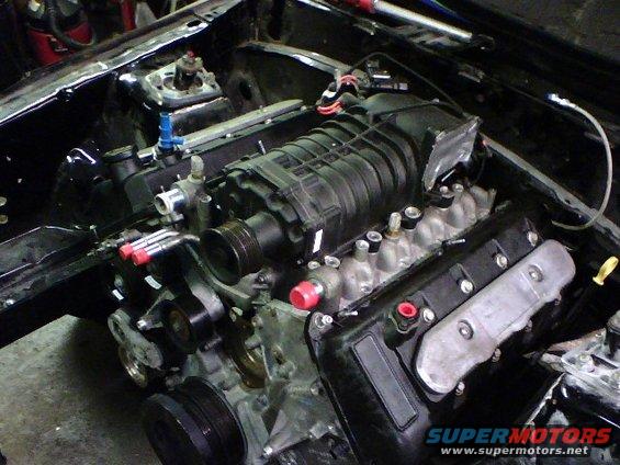 Supercharged V8 engine with black intake manifold and silver valve covers