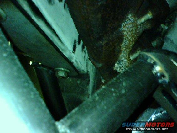 Close-up of engine components with rust and grime